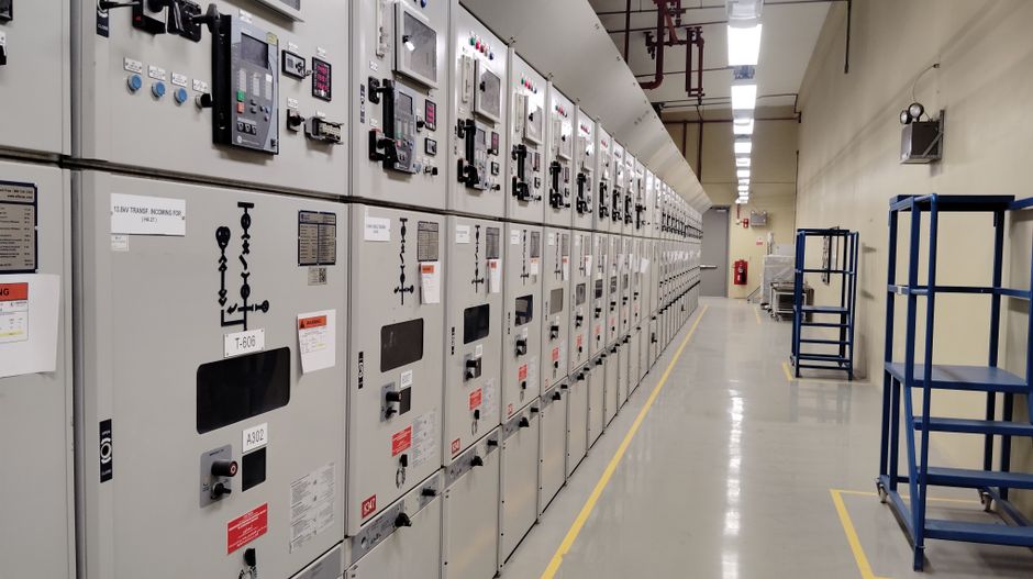 Industrial electrician working on equipment in a Montreal factory